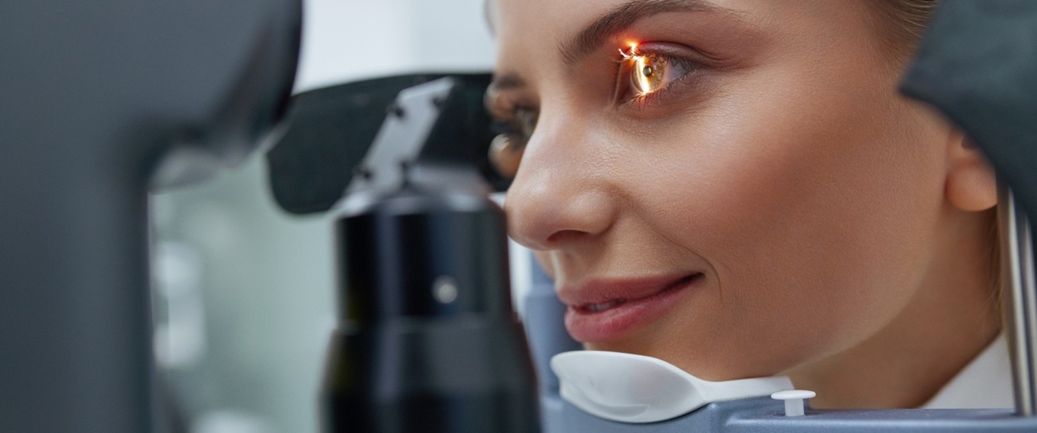 Woman with her head in ophthalmic apparatus 